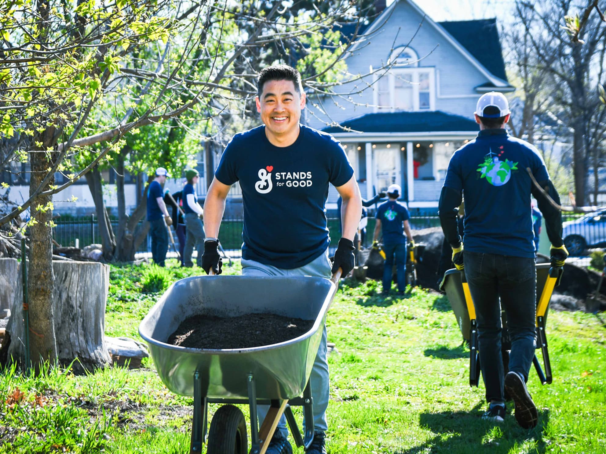 General Mills volunteer pushing a wheelbarrow